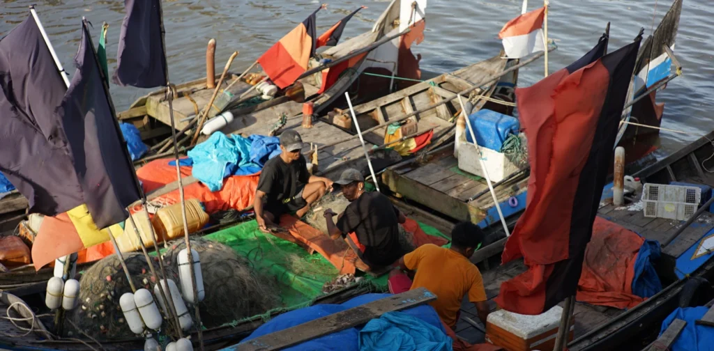 three fishers on a boat