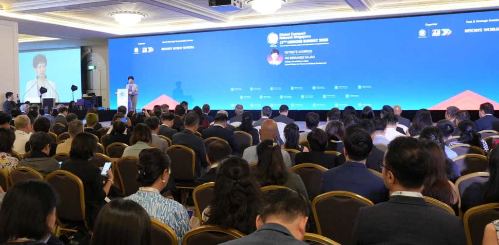 a person speaking on a podium in front of a crowd
