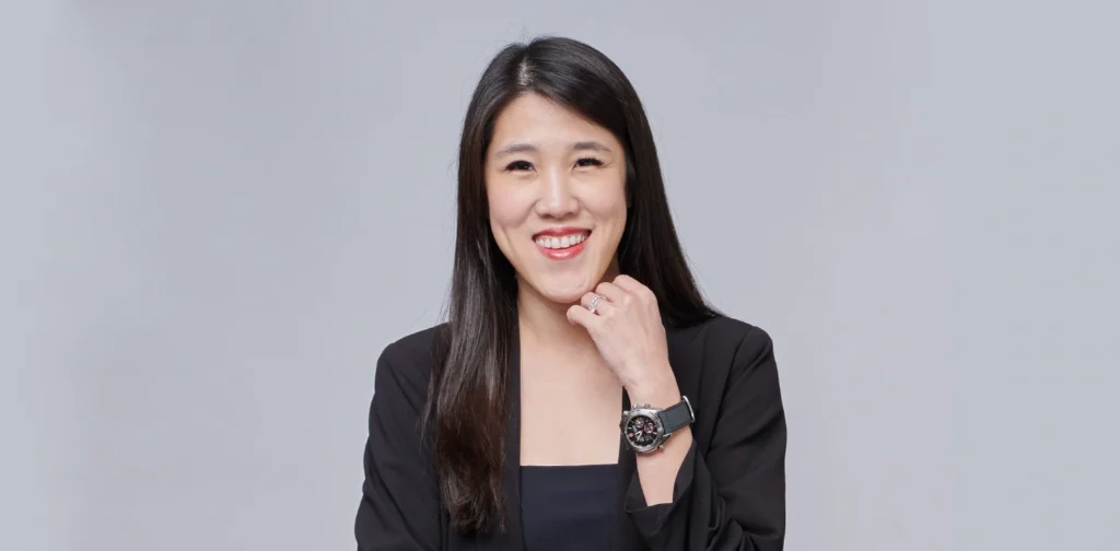 Jasmin Lim, a woman in a black business suit smiling