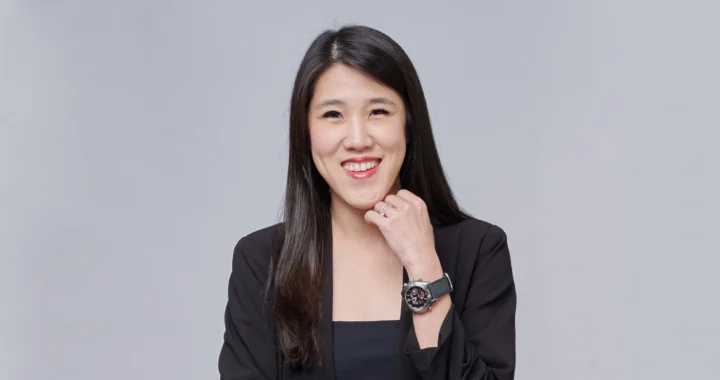 Jasmin Lim, a woman in a black business suit smiling