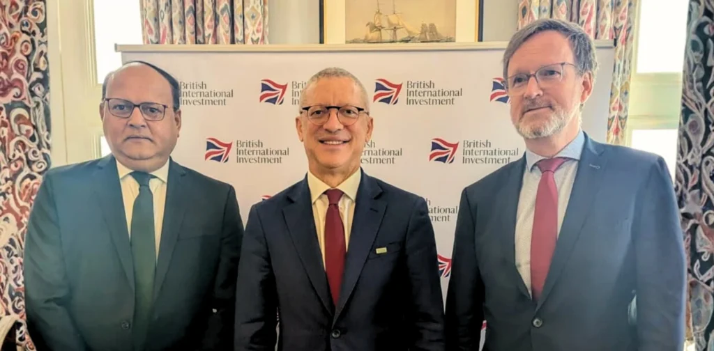 three men in suits smiling at the camera