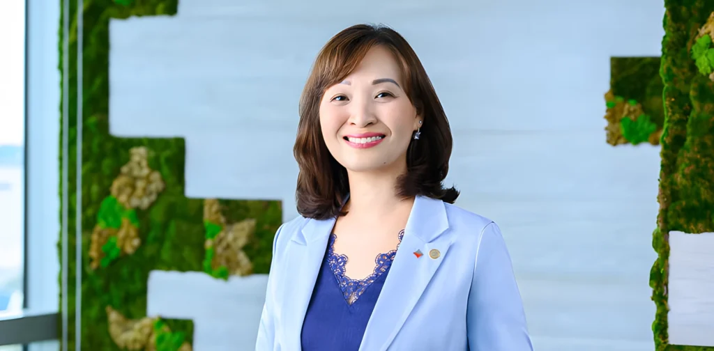 eu chin fen, a woman smiling at the camera wearing a suit