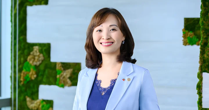eu chin fen, a woman smiling at the camera wearing a suit