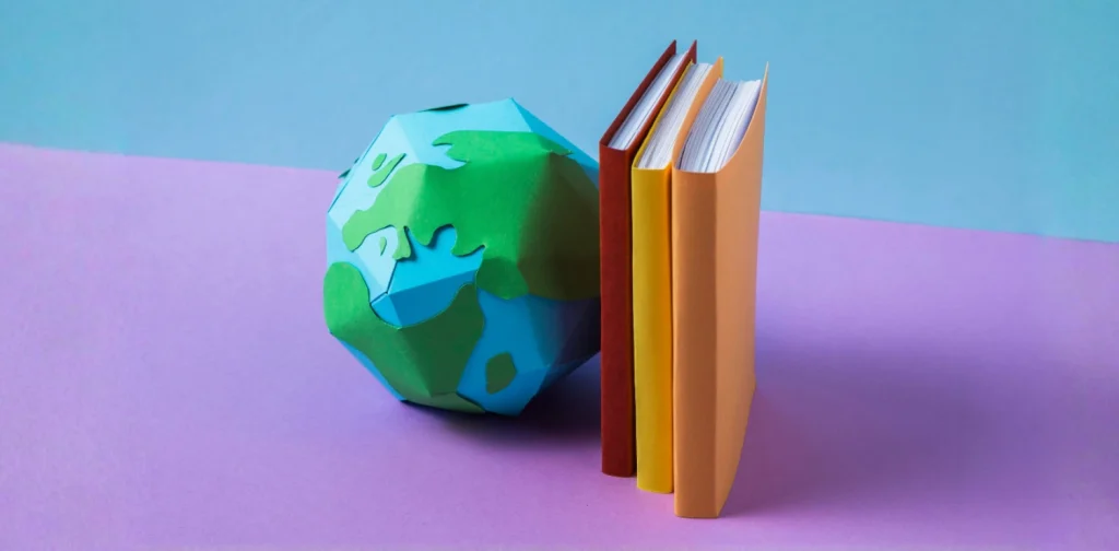 a globe figure propped against books