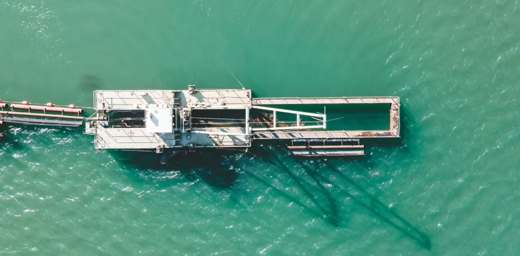 A dock and crane in the middle of an ocean