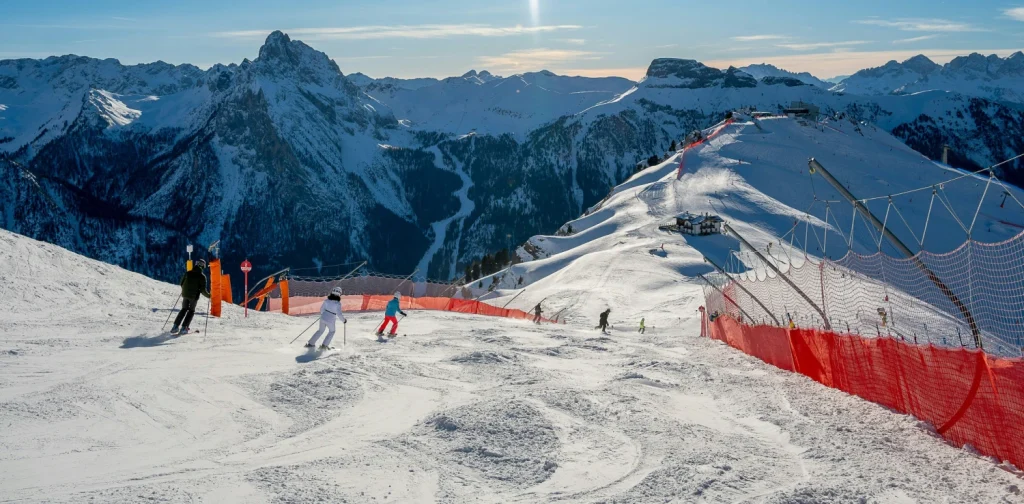 A group of people riding skis on the snow-covered slope