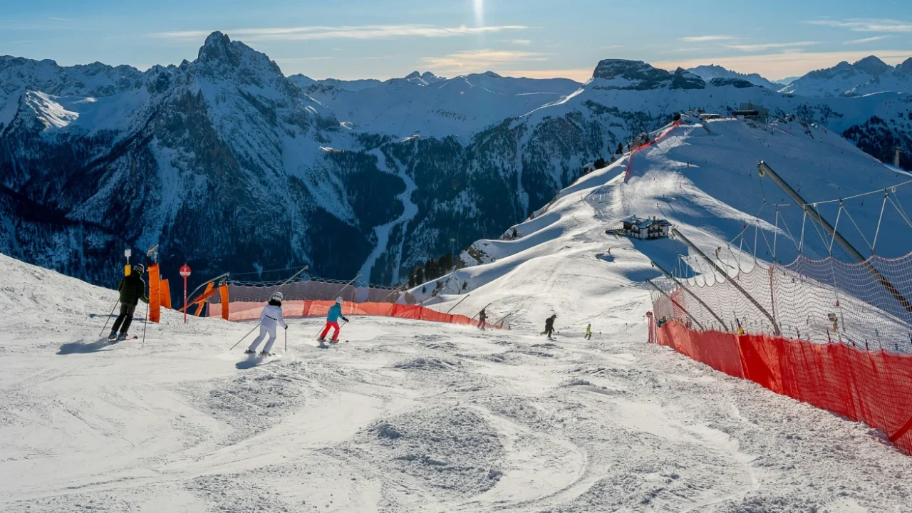 A group of people riding skis on the snow-covered slope
