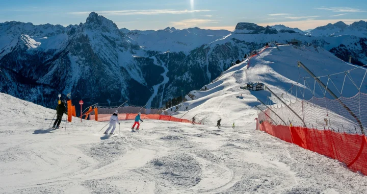 A group of people riding skis on the snow-covered slope