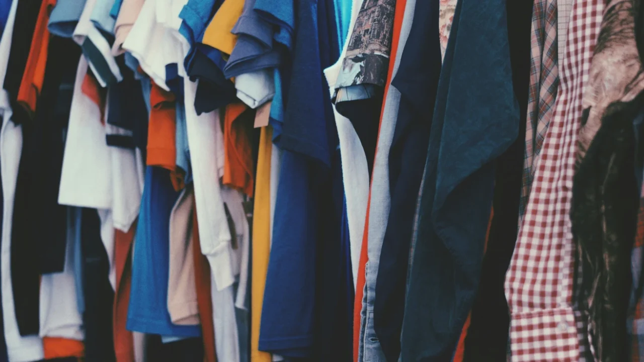 Colorful clothes hanging on a rack.