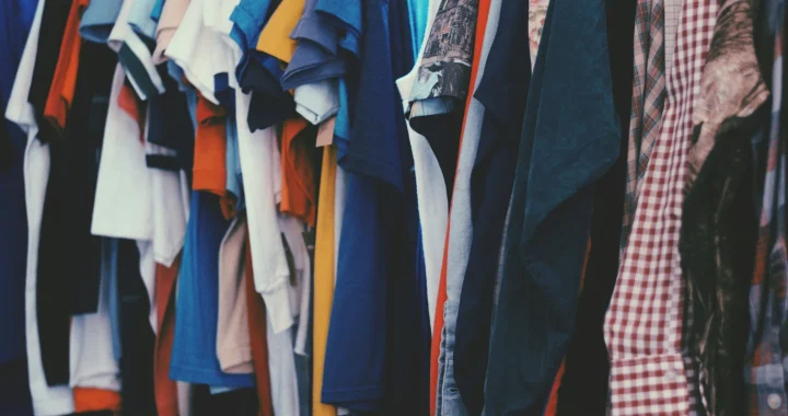 Colorful clothes hanging on a rack.