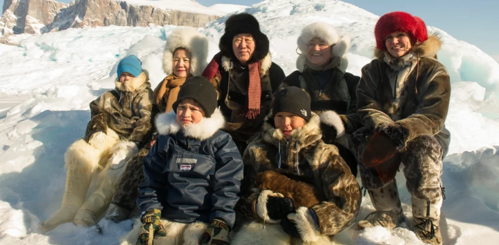 Ban Ki-moon with Inuit people with thick jackets on snow
