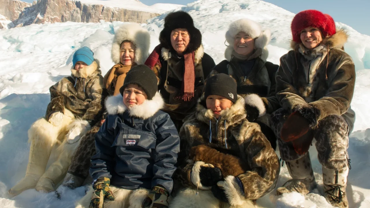 Ban Ki-moon with Inuit people with thick jackets on snow