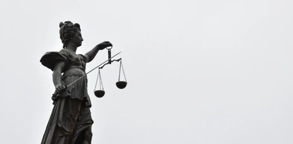 a statue of lady justice holding a scale of justice