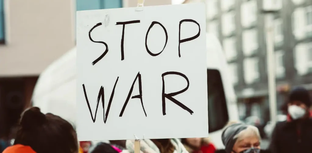 a protest sign that says ‘stop war’