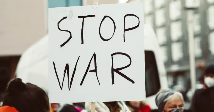 a protest sign that says ‘stop war’