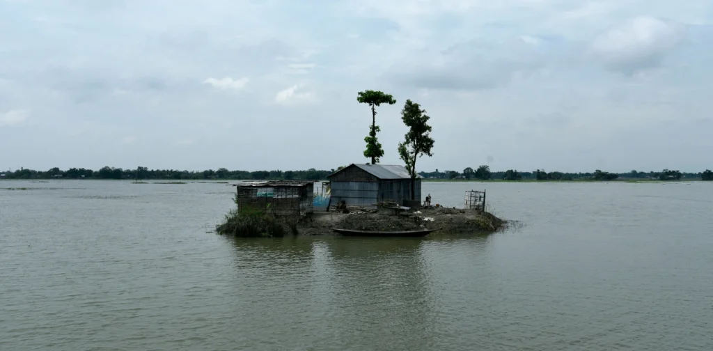 a small house surrounded by water