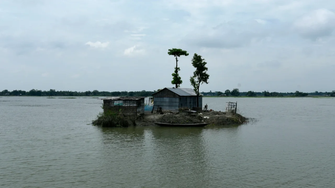 a small house surrounded by water