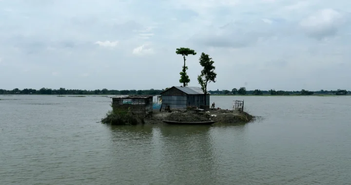 a small house surrounded by water