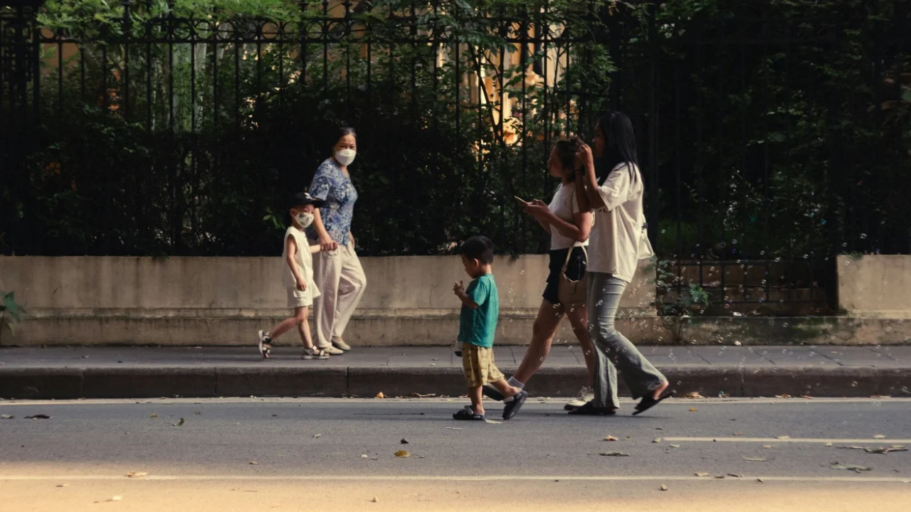 two sets of family with children walking the opposite ways on the road