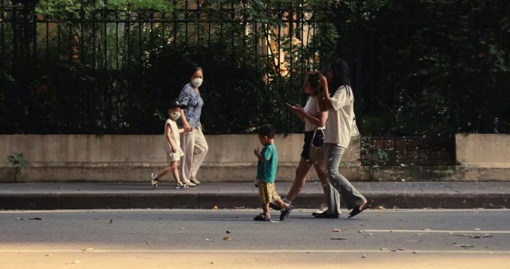 two sets of family with children walking the opposite ways on the road