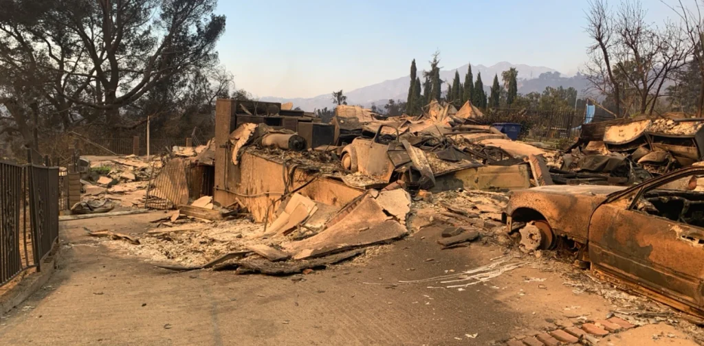 A burnt home and vehicle destroyed by the Eaton Fire in California, 2025.