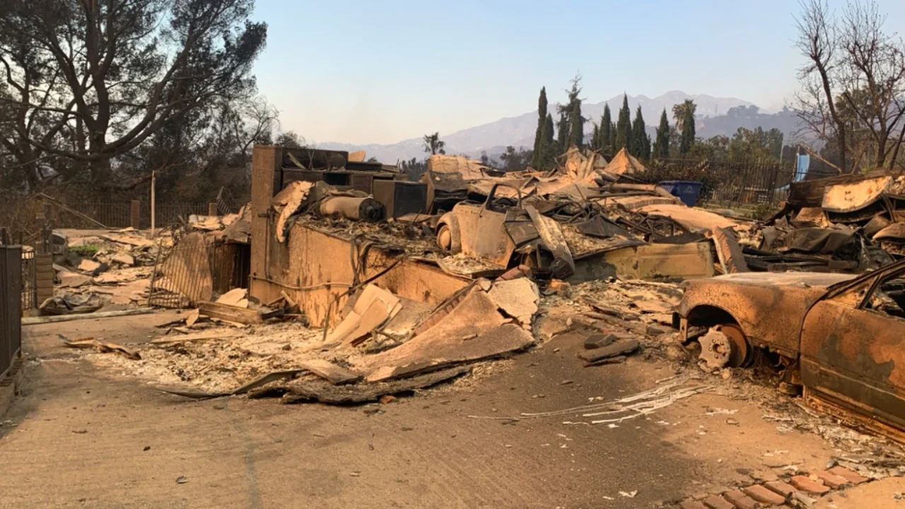 A burnt home and vehicle destroyed by the Eaton Fire in California, 2025.