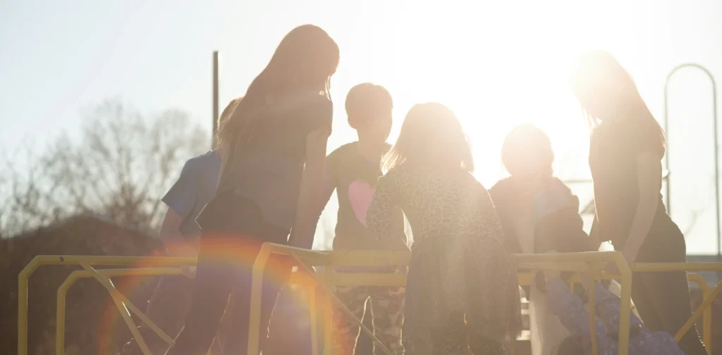 silhouette of children playing under the sun