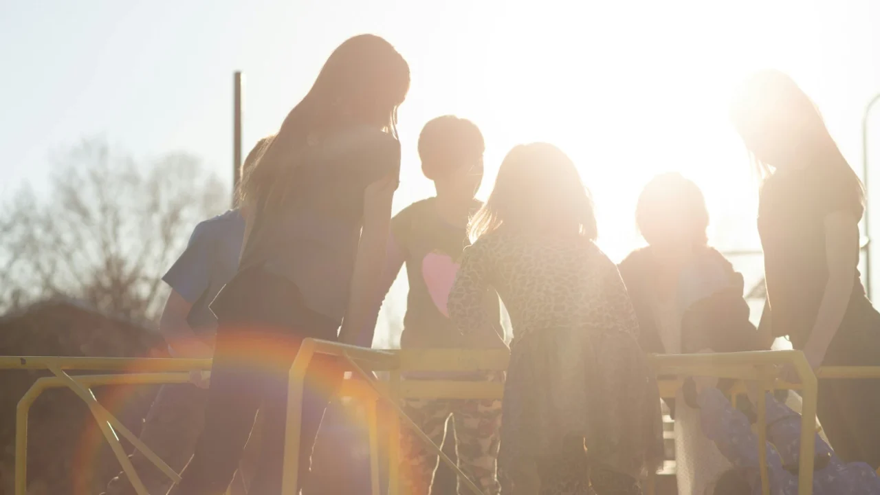 silhouette of children playing under the sun