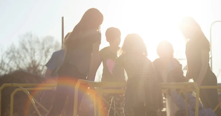 silhouette of children playing under the sun