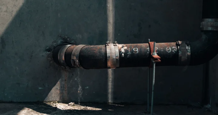 a leaking water pipe from a wall of a building