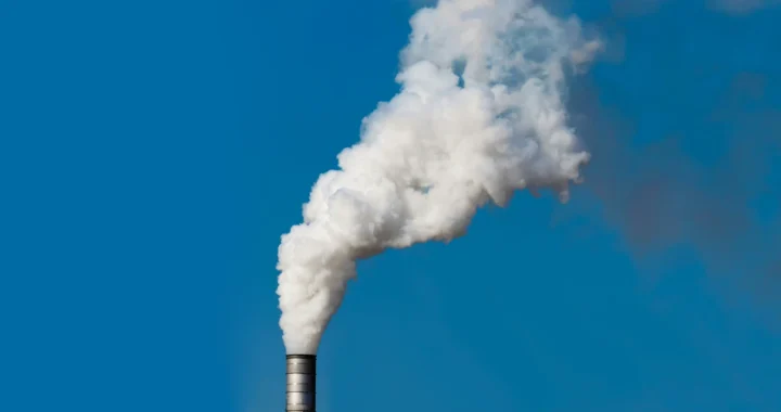 Thick white smoke coming out of factory chimney