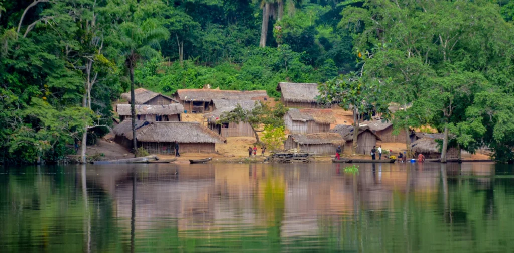a village nestled between a basin and a forest