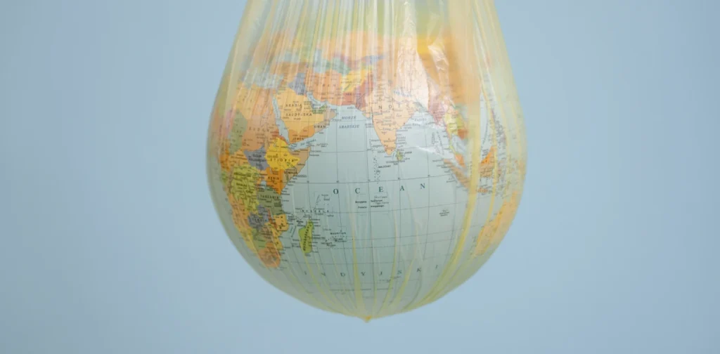 a globe hanging in a yellow plastic bag