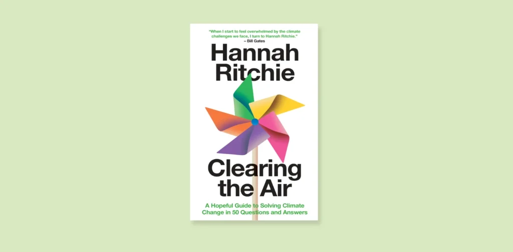 book cover with a colourful paper windmill of “Clearing the Air: A Hopeful Guide to Solving Climate Change in 50 Questions and Answers” by Hannah Ritchie.
