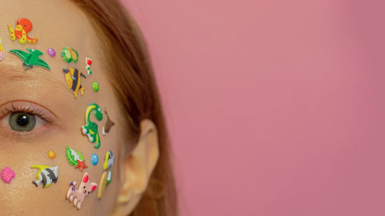 a closeup of a woman's face covered in stickers