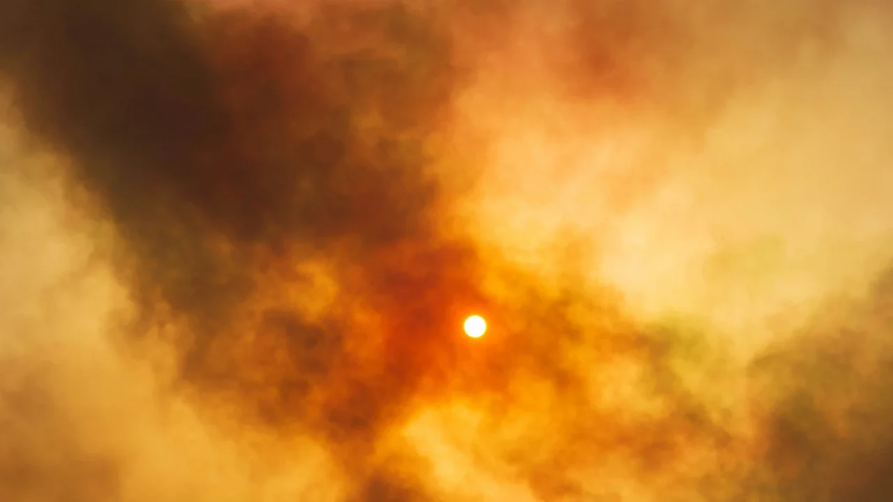 the sun shining through thick smoke